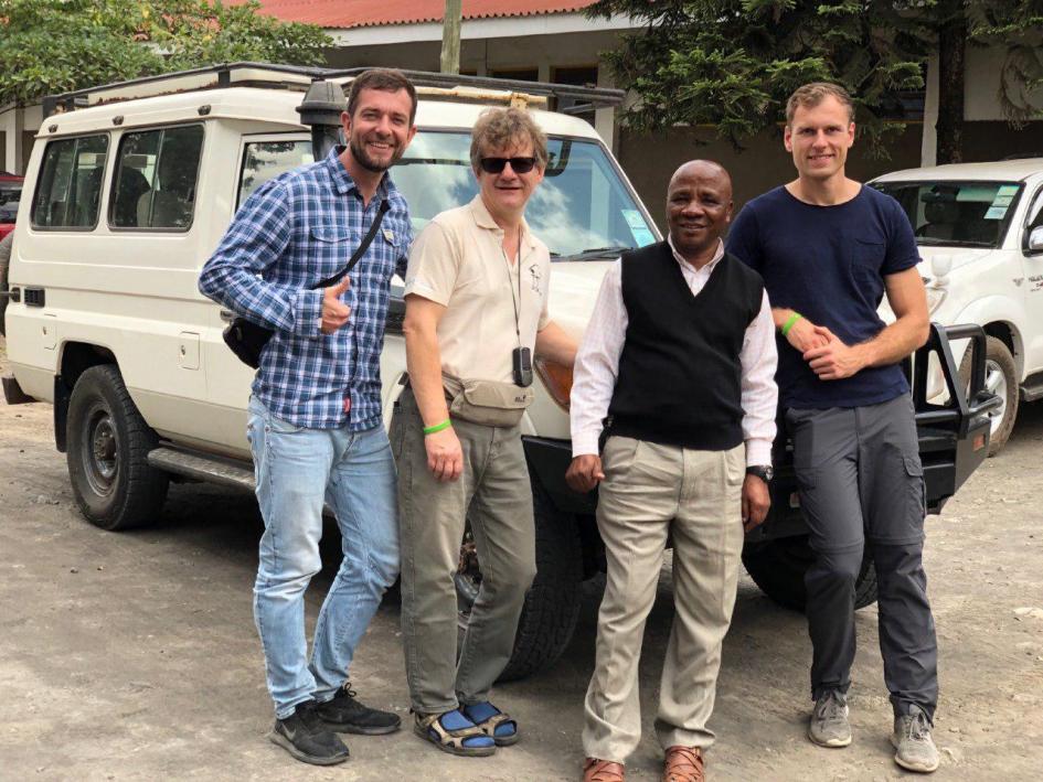 Picture of team in front of car